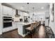 Modern kitchen with white cabinets, stainless steel appliances, and a quartz island with bar stool seating at 6635 Beacon Dr, Atlanta, GA 30328