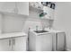 Functional laundry room with white cabinets and modern washer and dryer at 6635 Beacon Dr, Atlanta, GA 30328