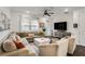 Bright living room with a large sectional sofa, modern fan, and natural light is perfect for relaxing at 6635 Beacon Dr, Atlanta, GA 30328