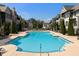 Community swimming pool surrounded by townhomes, with plenty of lounge chairs at 6635 Beacon Dr, Atlanta, GA 30328