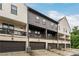 Street view of attractive townhome exteriors with brick garages and balconies at 6635 Beacon Dr, Atlanta, GA 30328