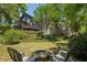 Spacious backyard featuring a cozy fire pit area and a charming view of the home's exterior at 1539 Marbut Se Ave, Atlanta, GA 30316