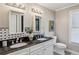 Elegant bathroom with dual sinks, a black granite countertop, and decorative lighting at 1539 Marbut Se Ave, Atlanta, GA 30316