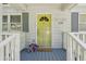 Close up of the front porch with a yellow door, East Atlanta sign, and flower decorations at 1539 Marbut Se Ave, Atlanta, GA 30316