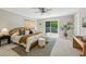 Cozy main bedroom featuring a ceiling fan, access to a private balcony, and stylish décor at 1539 Marbut Se Ave, Atlanta, GA 30316