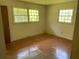 Cozy bedroom featuring hardwood floors and natural light from the surrounding windows at 2703 Arrowood Dr, East Point, GA 30344