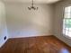Sunny dining room featuring hardwood floors and a classic chandelier at 2703 Arrowood Dr, East Point, GA 30344