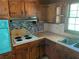 Efficient kitchen design with light countertops, dark cabinetry, and an electric cooktop at 2703 Arrowood Dr, East Point, GA 30344
