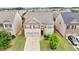 Elevated view of a suburban home featuring a manicured lawn, established landscaping, and a two-car garage at 556 Emporia Loop, Mcdonough, GA 30253
