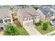 Aerial view of a two-story home with a two-car garage and lush, green landscaping at 556 Emporia Loop, Mcdonough, GA 30253