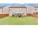 Spacious, fenced backyard showcasing a well-maintained lawn and cozy gazebo seating area at 556 Emporia Loop, Mcdonough, GA 30253