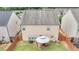 A view of the home's backyard with green grass, a fence and patio set with table and chairs at 556 Emporia Loop, Mcdonough, GA 30253