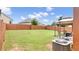 Lush, green backyard featuring a large lawn, wooden fence, and outdoor gazebo with furniture at 556 Emporia Loop, Mcdonough, GA 30253