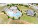 Aerial view of the community pool with bath house and grassy area at 556 Emporia Loop, Mcdonough, GA 30253