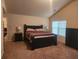 Spacious main bedroom featuring a tray ceiling, carpet floors, and ample natural light at 556 Emporia Loop, Mcdonough, GA 30253