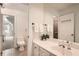 Bright bathroom featuring a dual sink vanity, decorative plant, and tiled flooring at 5940 Plantation Dr, Roswell, GA 30075