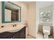 Bathroom with tile flooring, dark wood vanity, and a blue framed mirror at 5940 Plantation Dr, Roswell, GA 30075