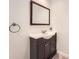 Bathroom featuring a modern vanity with marble countertop and framed mirror at 5940 Plantation Dr, Roswell, GA 30075