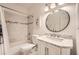 Bright bathroom featuring marble countertops, modern fixtures, and tiled shower/bath at 5940 Plantation Dr, Roswell, GA 30075