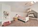 Attic bedroom with carpet, sloped ceilings, and a cozy platform bed at 5940 Plantation Dr, Roswell, GA 30075
