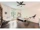 Bright bedroom with hardwood floors, a ceiling fan, and a wolf decal at 5940 Plantation Dr, Roswell, GA 30075