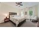 Bedroom features a queen-sized bed, side tables, neutral walls and plush carpet at 5940 Plantation Dr, Roswell, GA 30075