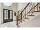 Inviting foyer with soaring ceilings, marble floor, and a staircase featuring decorative wrought iron at 5940 Plantation Dr, Roswell, GA 30075