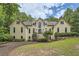 Stately home with mature trees, manicured lawn, and grand entrance staircase at 5940 Plantation Dr, Roswell, GA 30075