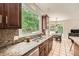 The kitchen sink overlooks views of the backyard and features stainless steel appliances and granite countertops at 5940 Plantation Dr, Roswell, GA 30075
