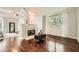 Bright living room featuring hardwood floors, a fireplace, and neutral decor at 5940 Plantation Dr, Roswell, GA 30075