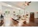 Bright and airy living room featuring a fireplace, skylights, and hardwood floors at 5940 Plantation Dr, Roswell, GA 30075