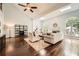 Spacious living room with fireplace, large windows, vaulted ceiling and hardwood floors at 5940 Plantation Dr, Roswell, GA 30075