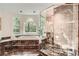 Stunning main bathroom featuring a soaking tub, standing shower, and forest views at 5940 Plantation Dr, Roswell, GA 30075
