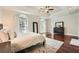 Large main bedroom with hardwood floors, tray ceiling, and lots of light at 5940 Plantation Dr, Roswell, GA 30075