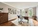 Bright office with large windows, desk, and display cabinet at 5940 Plantation Dr, Roswell, GA 30075