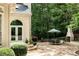 A serene outdoor patio with dining set and outdoor fireplace, perfect for entertaining and enjoying nature at 5940 Plantation Dr, Roswell, GA 30075