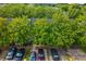 An aerial view of well-maintained townhomes, showcasing mature trees, and convenient parking; a desirable community setting at 1851 Grove Way, Hampton, GA 30228