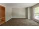Spacious bedroom with neutral-toned walls, plush carpeting, and a bright window at 1851 Grove Way, Hampton, GA 30228