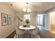 Cozy dining area with a marble table, chandelier lighting, and decor that enhances the space at 1851 Grove Way, Hampton, GA 30228