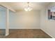 Open dining space with carpet, chandelier lighting, and a view into the kitchen area for easy serving at 1851 Grove Way, Hampton, GA 30228