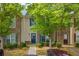 Inviting townhouse with stone and siding accents, blue door, and mature trees in a well-kept community at 1851 Grove Way, Hampton, GA 30228