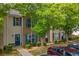 Charming townhome featuring blue shutters and stone accents, complemented by mature trees at 1851 Grove Way, Hampton, GA 30228