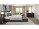 Bedroom with natural light, stylish furniture, and carpeted floors at 1851 Grove Way, Hampton, GA 30228