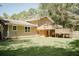 Large backyard with a wooden deck and mature trees at 2592 King Louis Ne Rd, Conyers, GA 30012