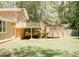 Expansive backyard with a spacious deck, lush green lawn, and privacy fence, ideal for outdoor living at 2592 King Louis Ne Rd, Conyers, GA 30012