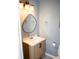 Bathroom showcasing a wood vanity and unique light fixture at 2592 King Louis Ne Rd, Conyers, GA 30012