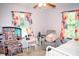 Bedroom with dollhouse, vanity and colorful curtains at 2592 King Louis Ne Rd, Conyers, GA 30012