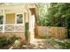 Charming home exterior with a well-maintained lawn, wooden fence, and tasteful landscaping at 2592 King Louis Ne Rd, Conyers, GA 30012