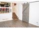 Living room with barn door and stairs to another level at 2592 King Louis Ne Rd, Conyers, GA 30012