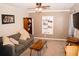 Comfortable living room featuring a cozy sofa, stylish furnishings, and modern decor elements at 2592 King Louis Ne Rd, Conyers, GA 30012